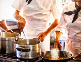 Chefs preparing food at stove